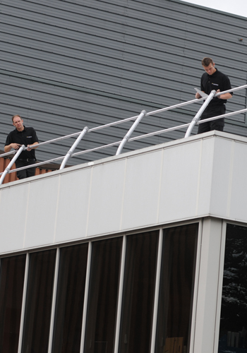 US Fall Protection team demonstrating fall safety solutions for workers at heights in various industries.